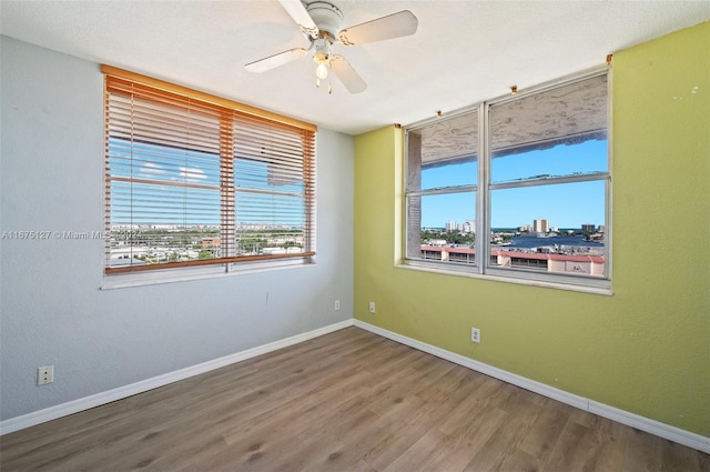 unfurnished room featuring ceiling fan and wood-type flooring