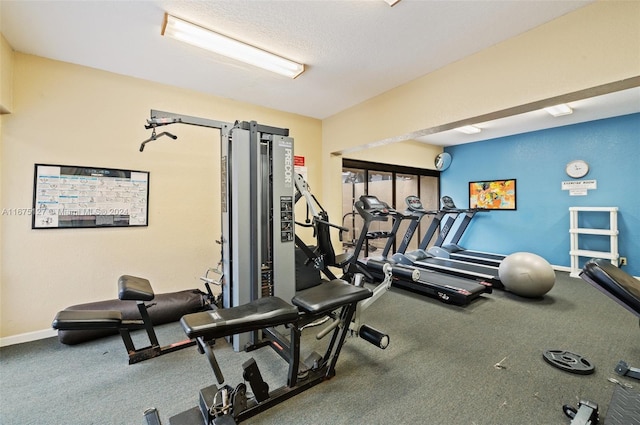 gym with carpet floors and a textured ceiling