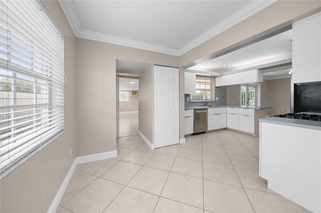 kitchen with white cabinets, light tile patterned floors, stainless steel dishwasher, and crown molding