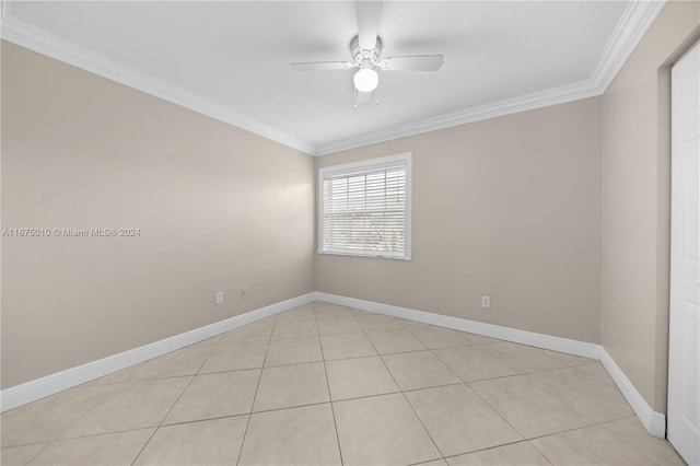 empty room featuring ceiling fan, ornamental molding, and light tile patterned flooring