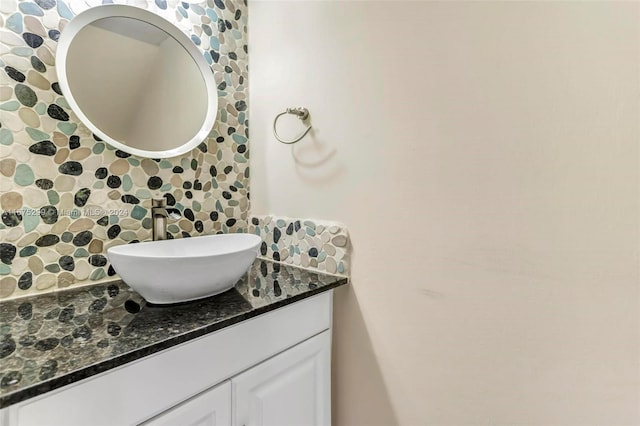 bathroom featuring vanity and backsplash