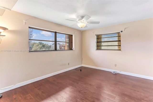 unfurnished room with dark hardwood / wood-style floors and ceiling fan