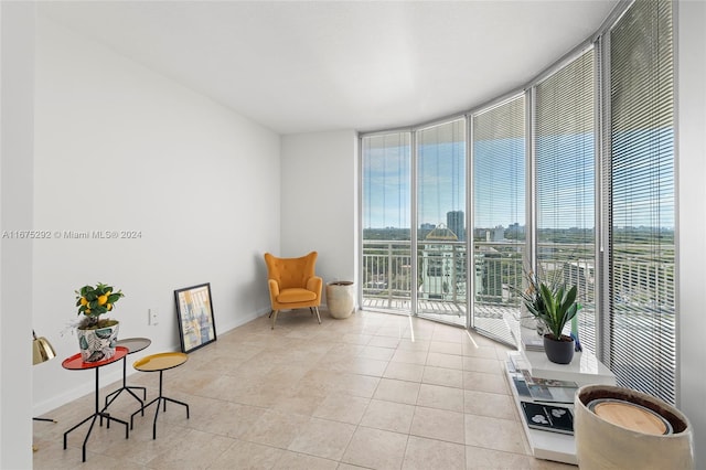 sitting room featuring light tile patterned flooring and floor to ceiling windows