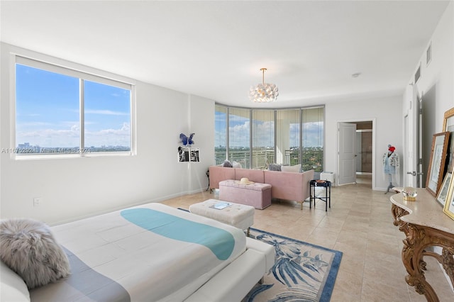 bedroom featuring light tile patterned floors, floor to ceiling windows, and an inviting chandelier