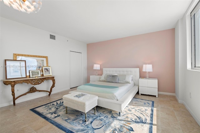 bedroom with a closet and light tile patterned floors