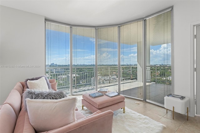 living room featuring expansive windows and light tile patterned floors