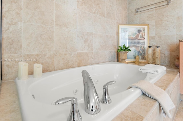 bathroom with tiled tub and tile walls