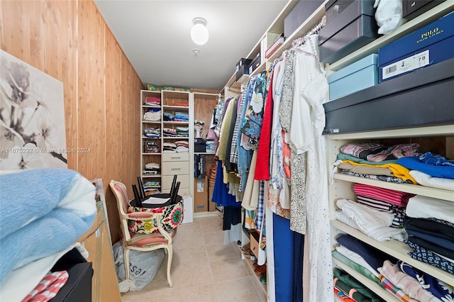 walk in closet with light tile patterned flooring