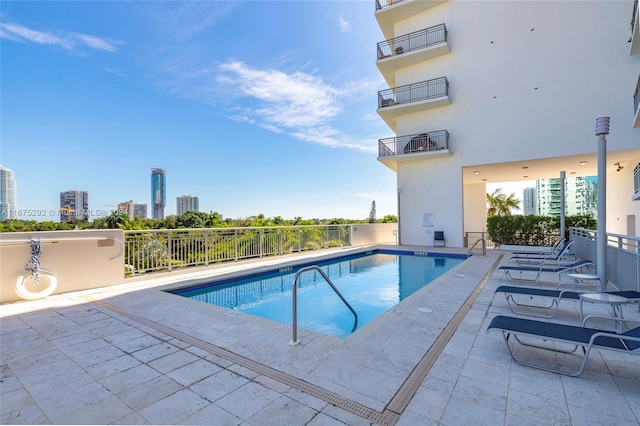 view of swimming pool featuring a patio area