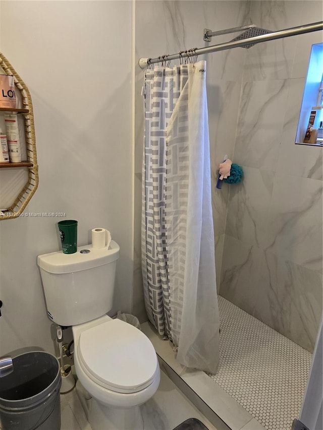 bathroom with toilet, tile patterned flooring, and walk in shower