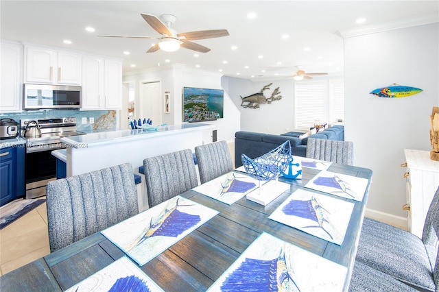 tiled dining room featuring crown molding and ceiling fan