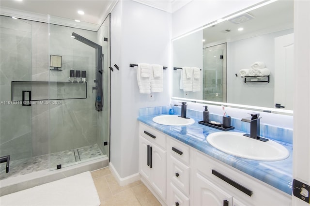 bathroom with vanity, tile patterned floors, ornamental molding, and an enclosed shower