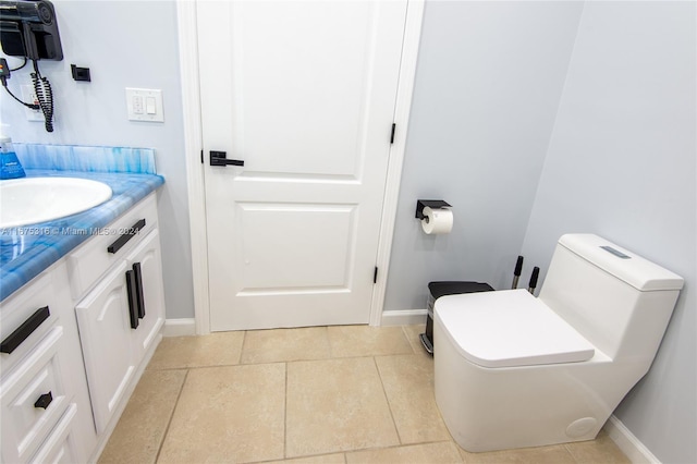 bathroom with vanity, toilet, and tile patterned floors