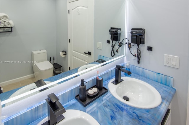 bathroom with vanity, toilet, and tile patterned floors