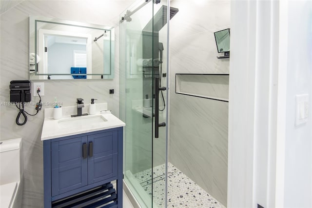 bathroom featuring vanity, toilet, tasteful backsplash, and an enclosed shower