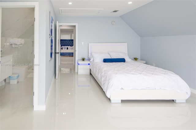 bedroom featuring connected bathroom and vaulted ceiling