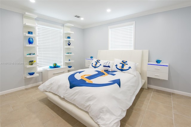 bedroom with crown molding and light tile patterned floors