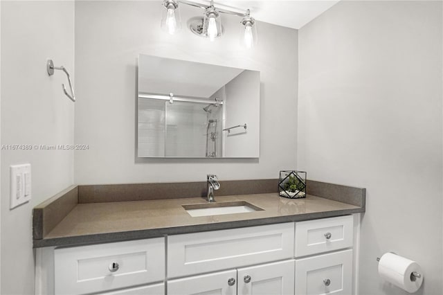 bathroom featuring vanity and a shower with door