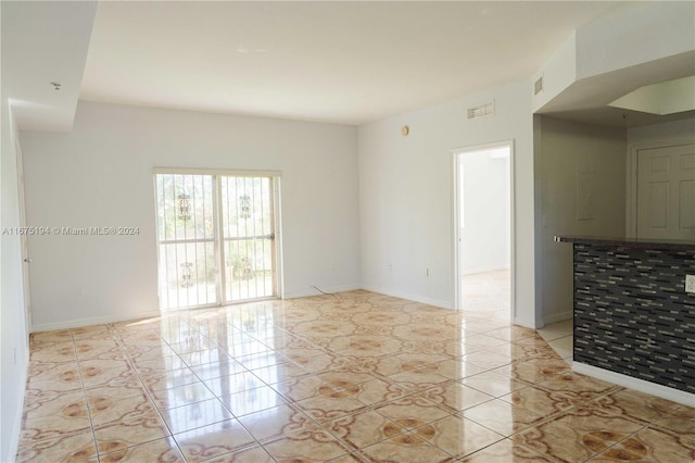 unfurnished room featuring light tile patterned floors