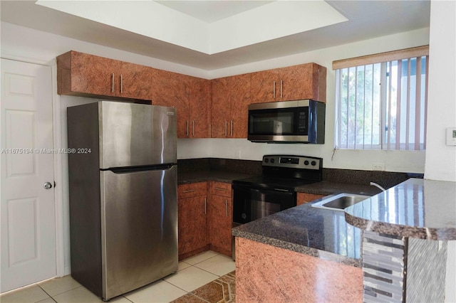 kitchen featuring sink, appliances with stainless steel finishes, kitchen peninsula, and light tile patterned floors