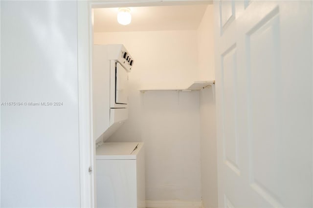 laundry room with stacked washer / dryer