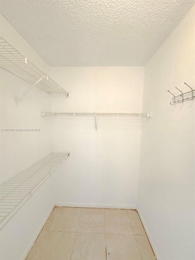 4045 W Mcnab Rd Unit 106G, Pompano Beach, FL 33069 - walk in closet with light tile patterned floors