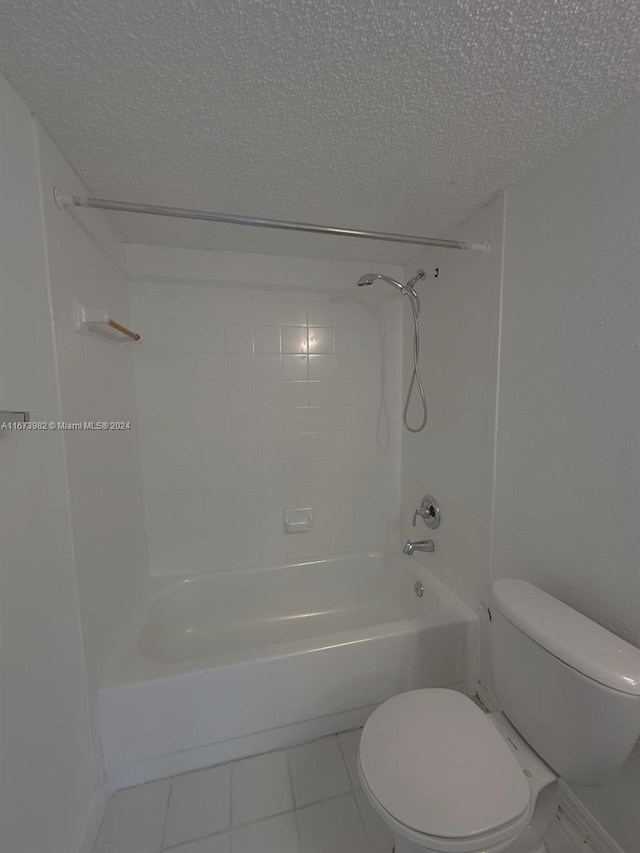 bathroom with shower / bath combination, tile patterned floors, a textured ceiling, and toilet