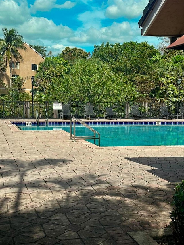 view of swimming pool with a patio area