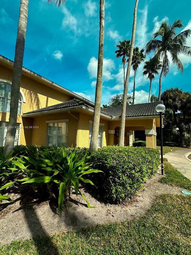 4045 W Mcnab Rd Unit 106G, Pompano Beach, FL 33069 - view of side of property with stucco siding and a tile roof