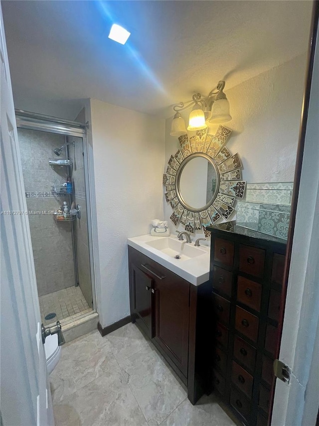 bathroom with an enclosed shower, vanity, and toilet