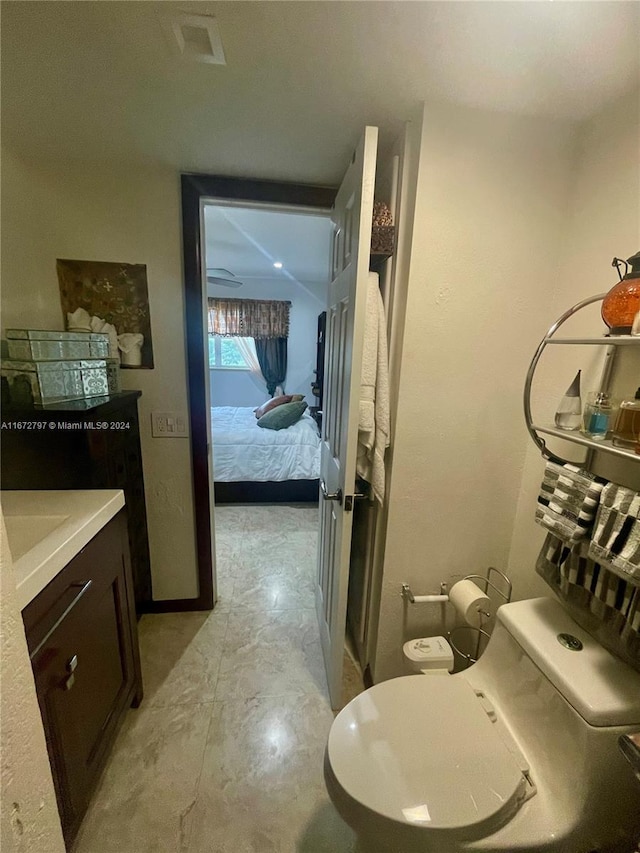 bathroom featuring vanity, toilet, and concrete floors