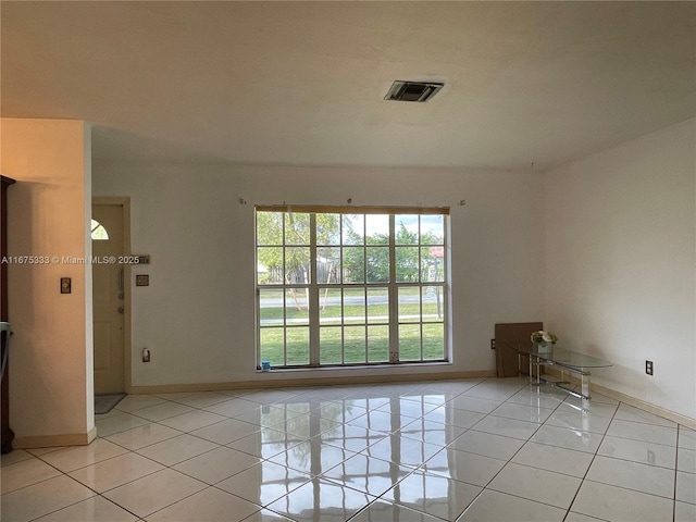 unfurnished room featuring light tile patterned floors