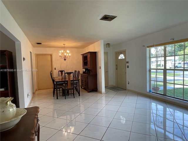 tiled dining area with a notable chandelier