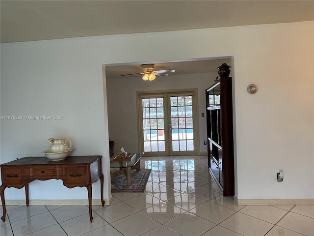 entryway featuring ceiling fan, light tile patterned floors, and french doors