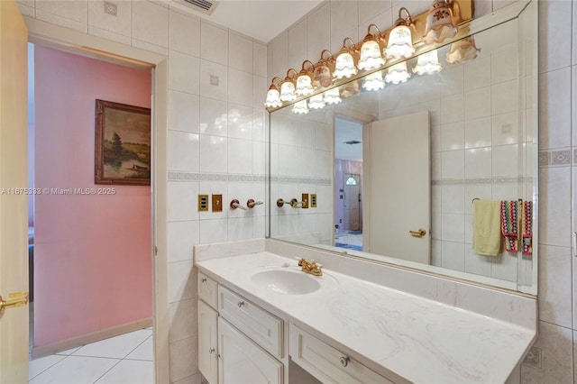 bathroom with tile walls, tile patterned floors, and vanity