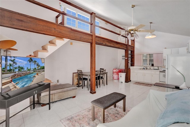 tiled living room featuring high vaulted ceiling, ceiling fan, and sink