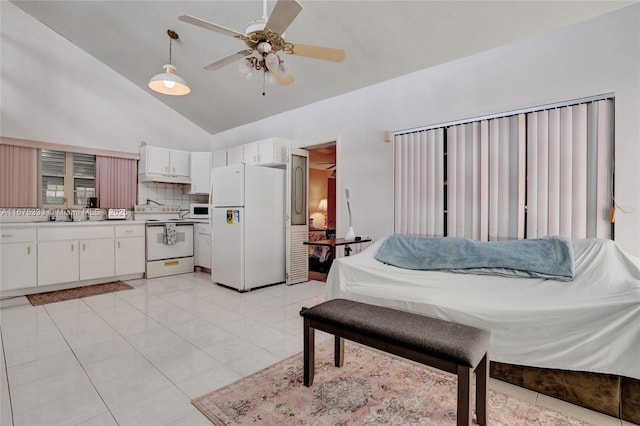 tiled bedroom featuring ceiling fan, sink, white refrigerator, and high vaulted ceiling