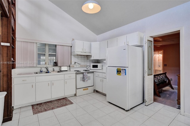 kitchen with light tile patterned floors, white cabinetry, sink, and white appliances