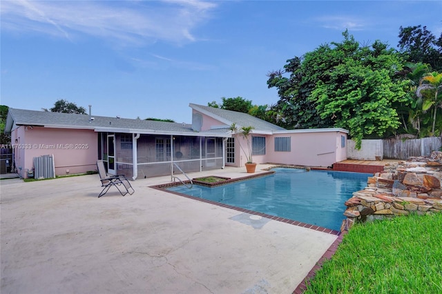 view of pool featuring a patio and a sunroom