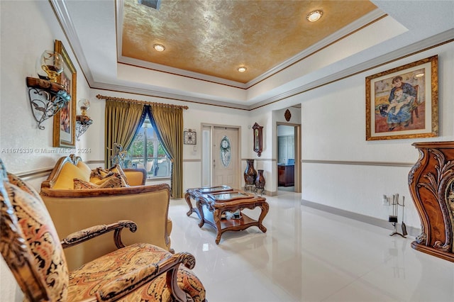 sitting room featuring a raised ceiling and ornamental molding