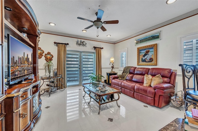 tiled living room featuring ceiling fan, a textured ceiling, and crown molding