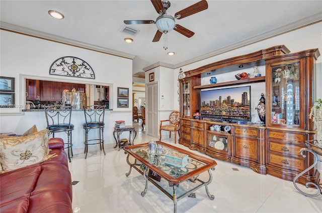 tiled living room with ornamental molding and ceiling fan