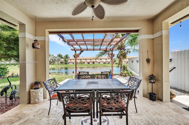 view of patio with ceiling fan and a water view