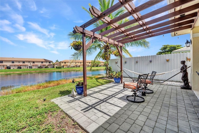 view of patio featuring a water view and a pergola