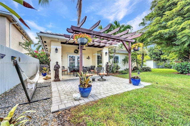 rear view of property with a patio, a lawn, and a pergola