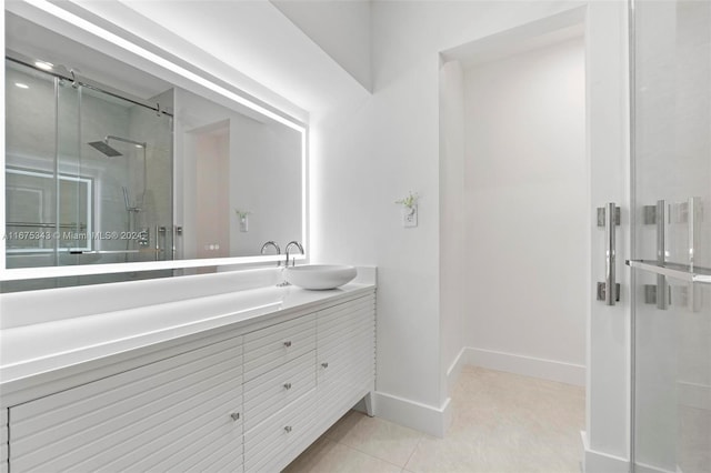 bathroom with tile patterned flooring, a shower with door, and vanity