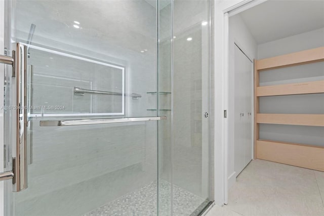 bathroom with a shower with door