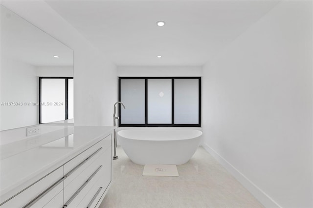 bathroom with vanity and a washtub