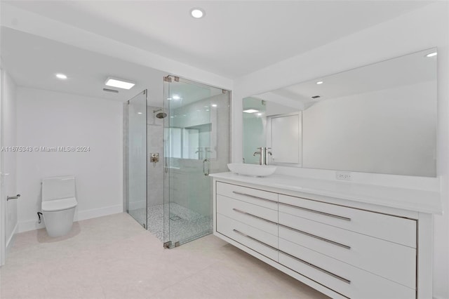 bathroom featuring an enclosed shower, vanity, and toilet