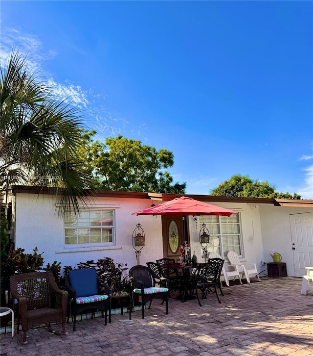 back of property with a patio